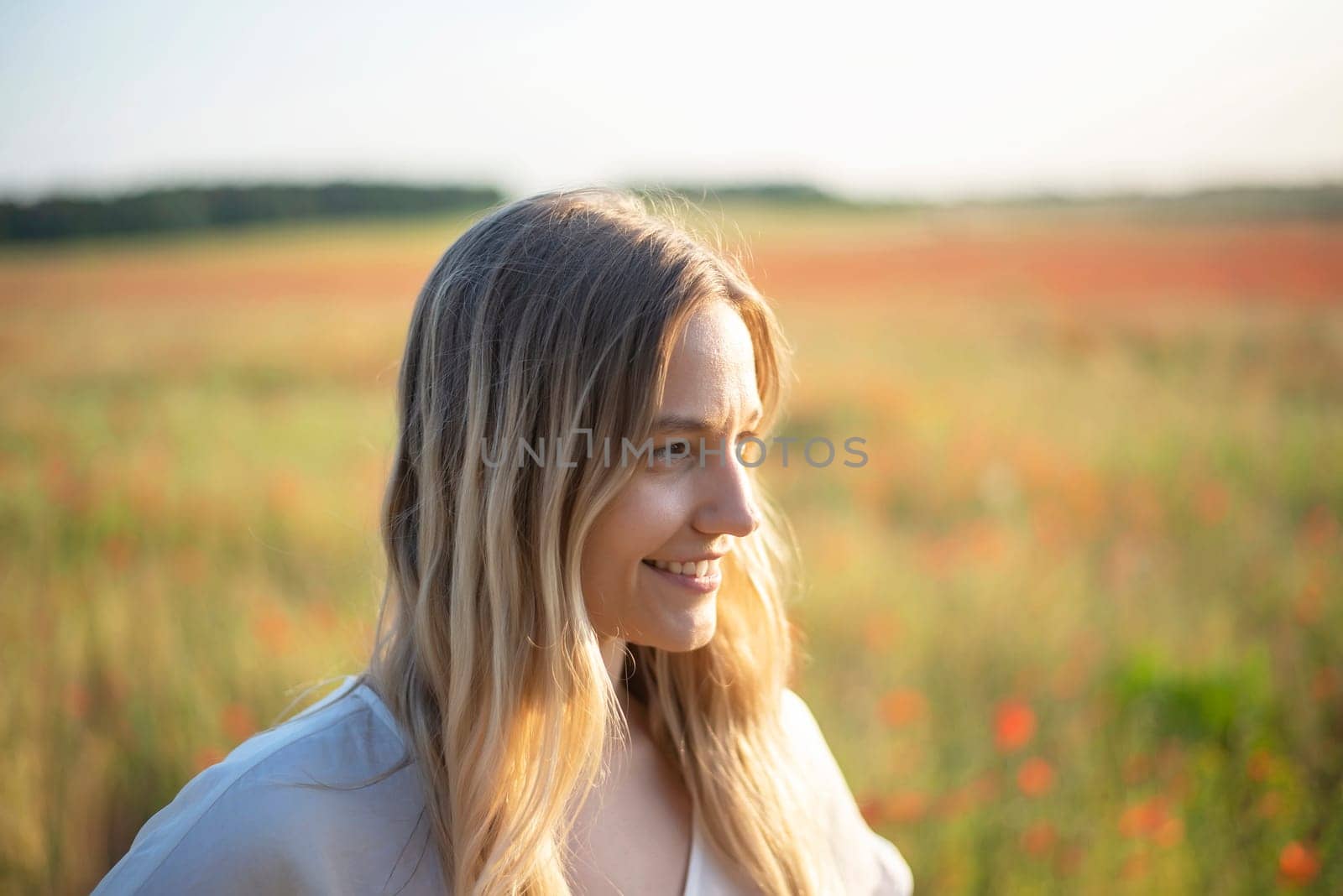 happy young woman in poppy field