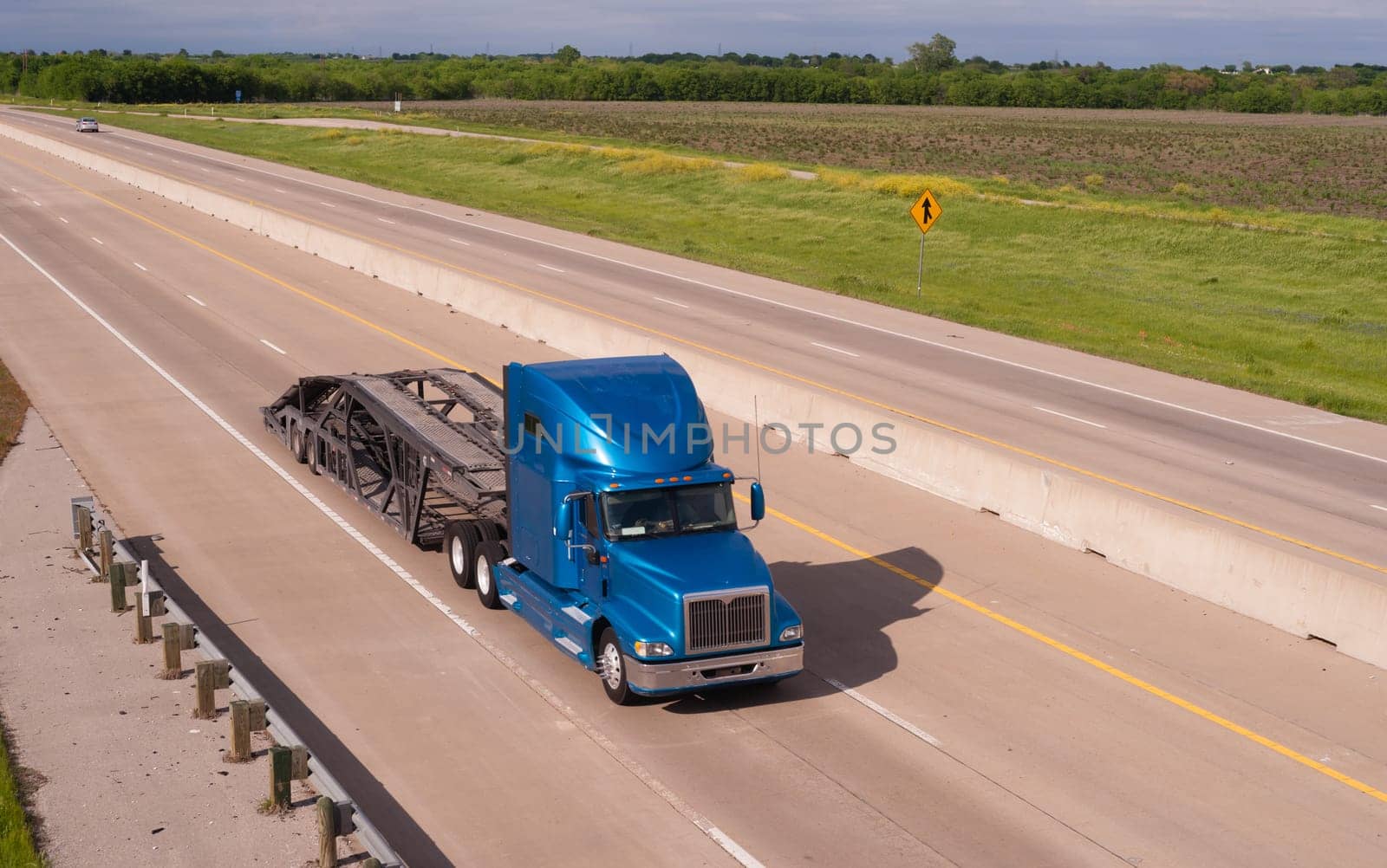 A big Rig car hauler rolls down the highway headed to pick up the next cargo