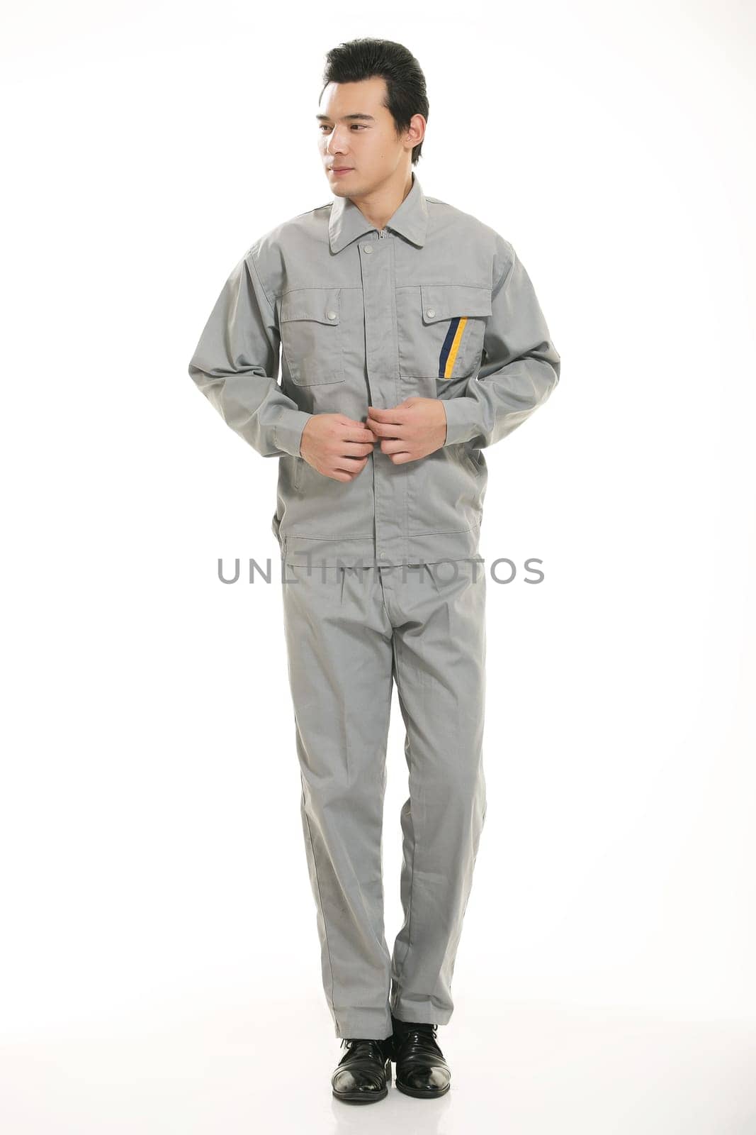 The young engineer various occupation clothing standing in front of a white background