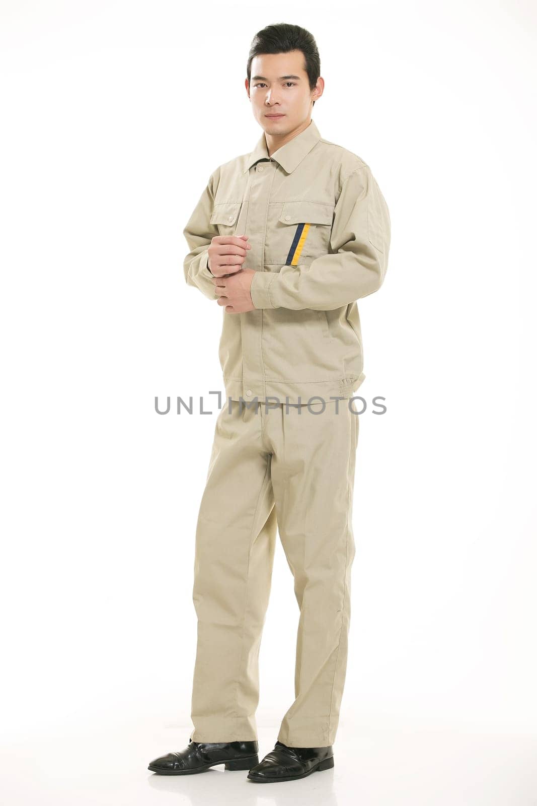 The young engineer various occupation clothing standing in front of a white background
