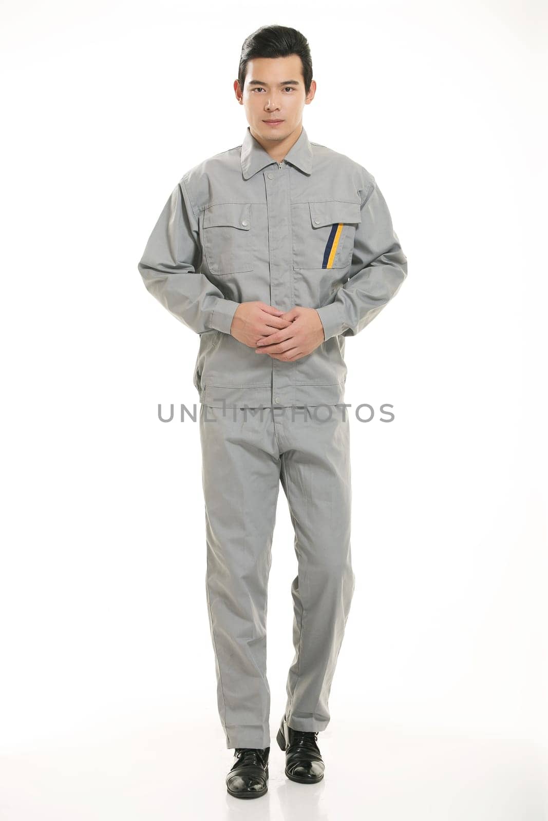 The young engineer various occupation clothing standing in front of a white background