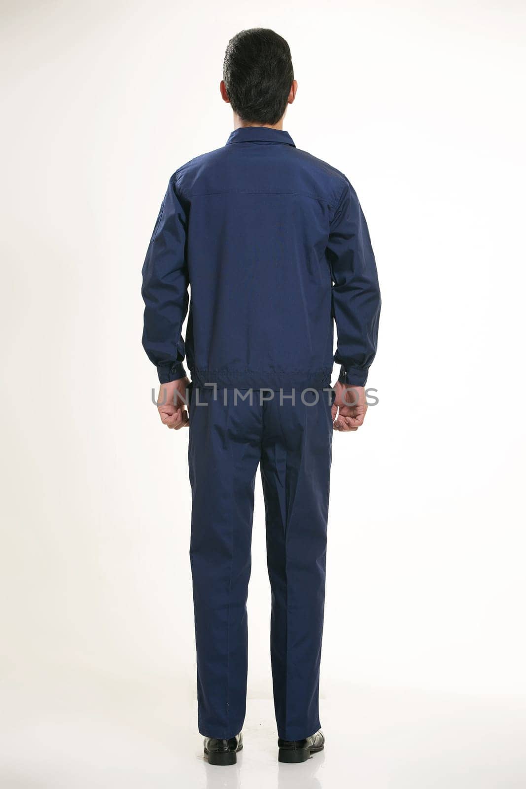 The young engineer various occupation clothing standing in front of a white background