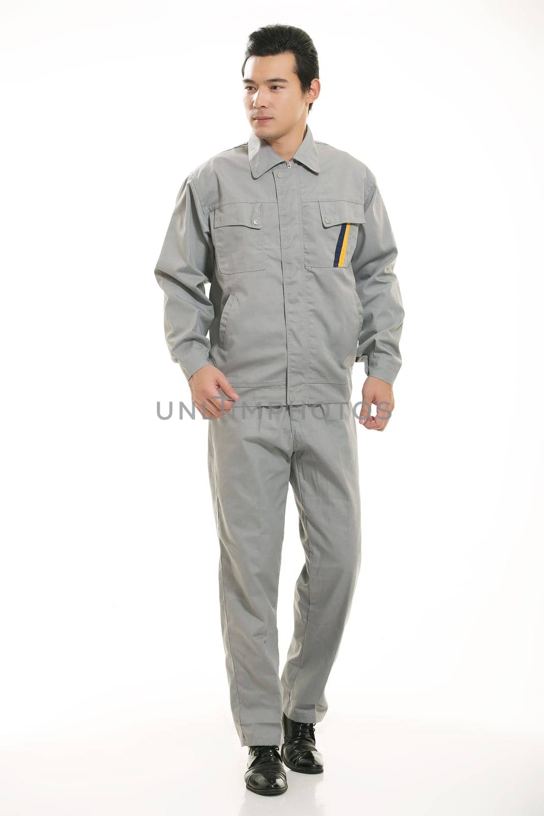 The young engineer various occupation clothing standing in front of a white background