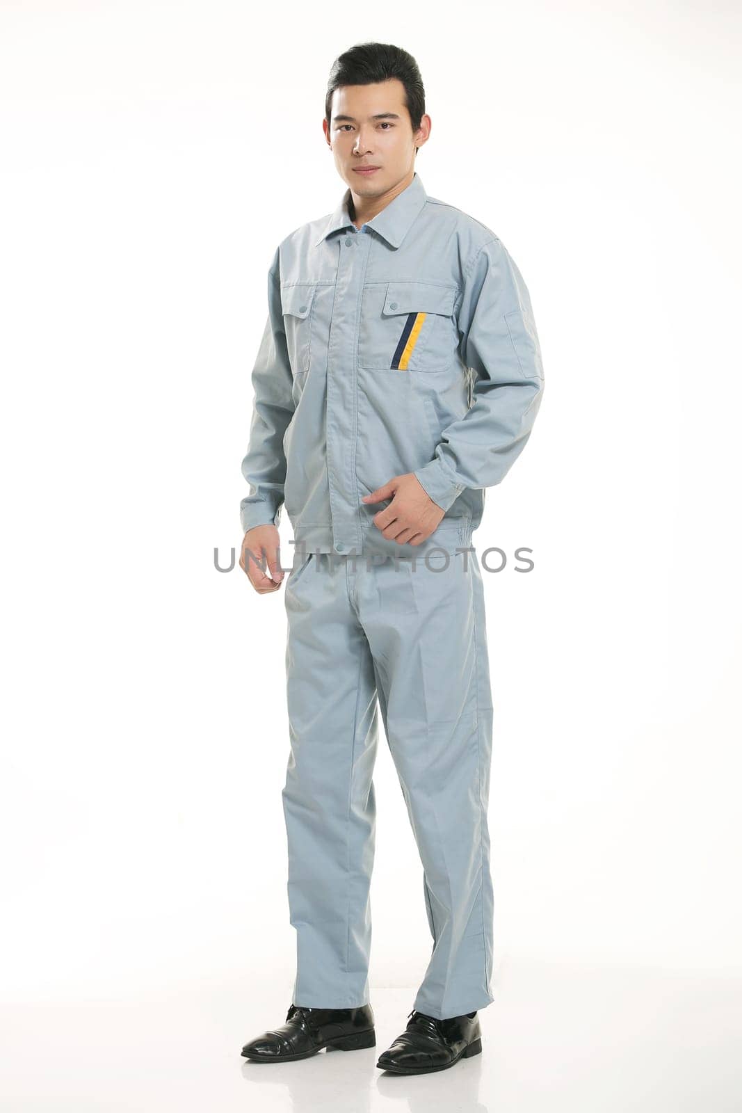 The young engineer various occupation clothing standing in front of a white background
