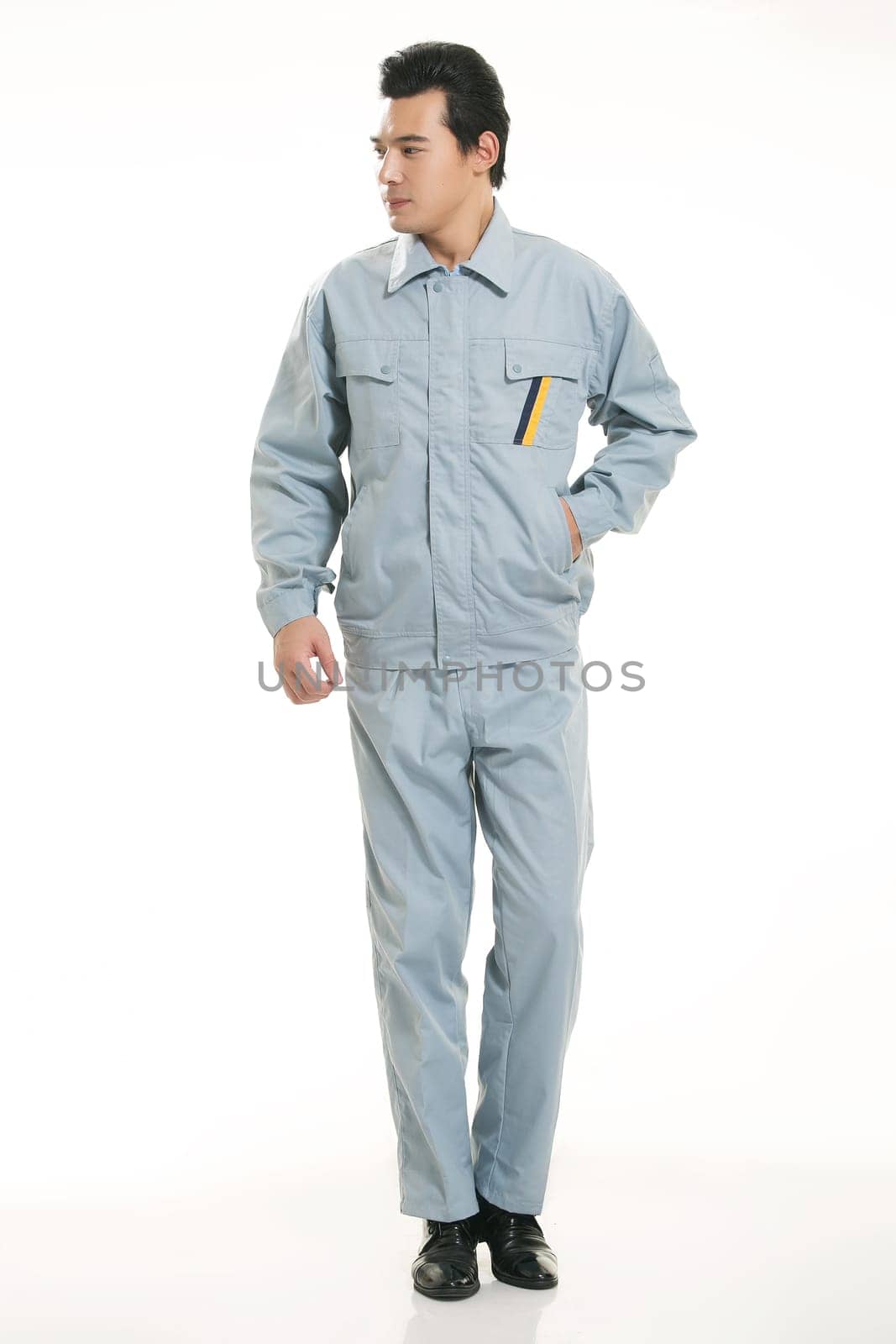 The young engineer various occupation clothing standing in front of a white background
