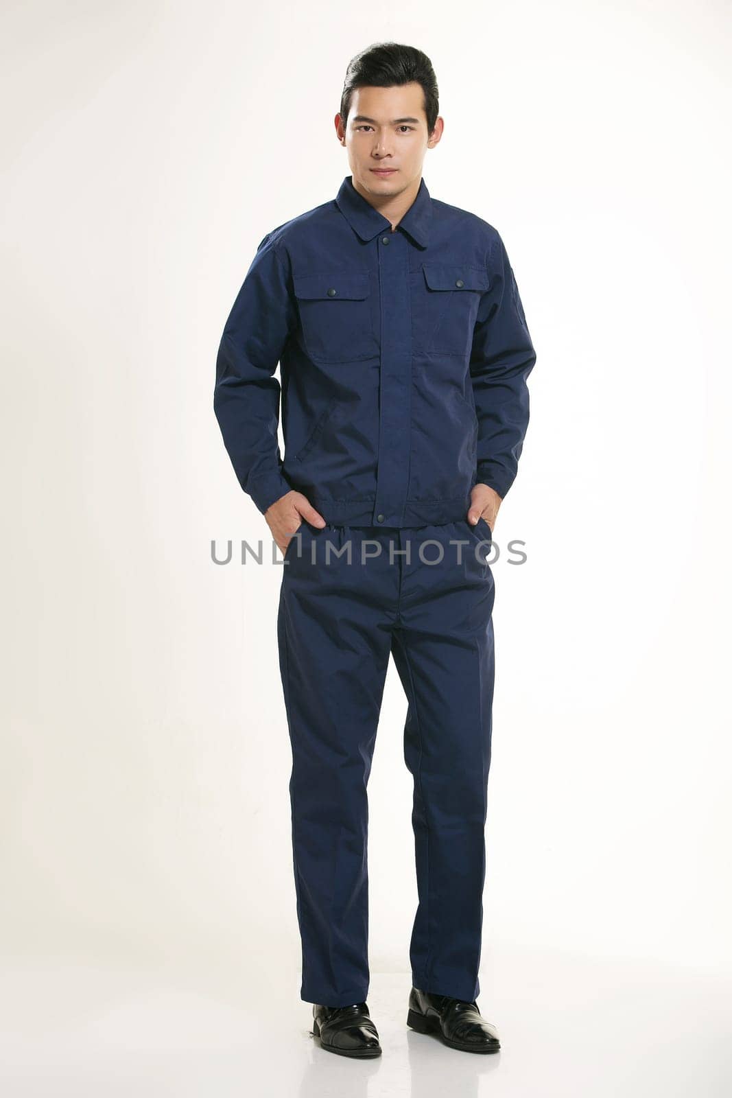 The young engineer various occupation clothing standing in front of a white background