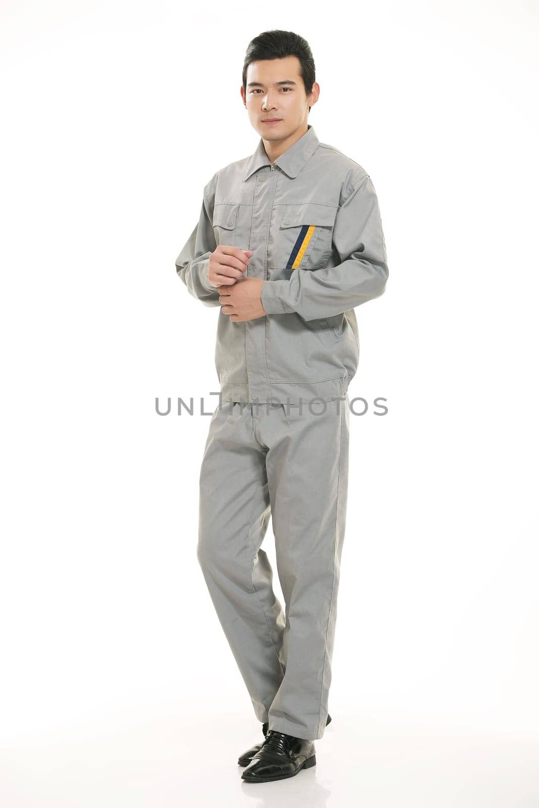 The young engineer various occupation clothing standing in front of a white background