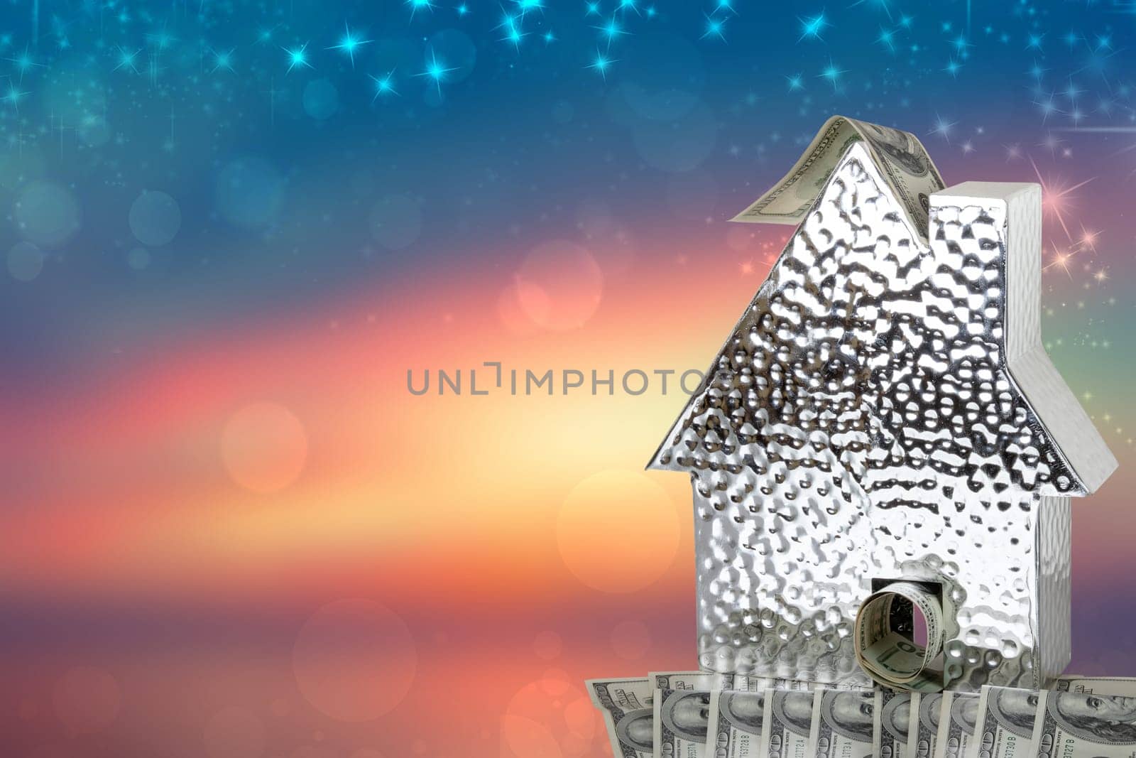 Business, money and finance concept. A metallic house model with many $100 banknotes isolated on a white background. Real estate and saving plans for house. Space.