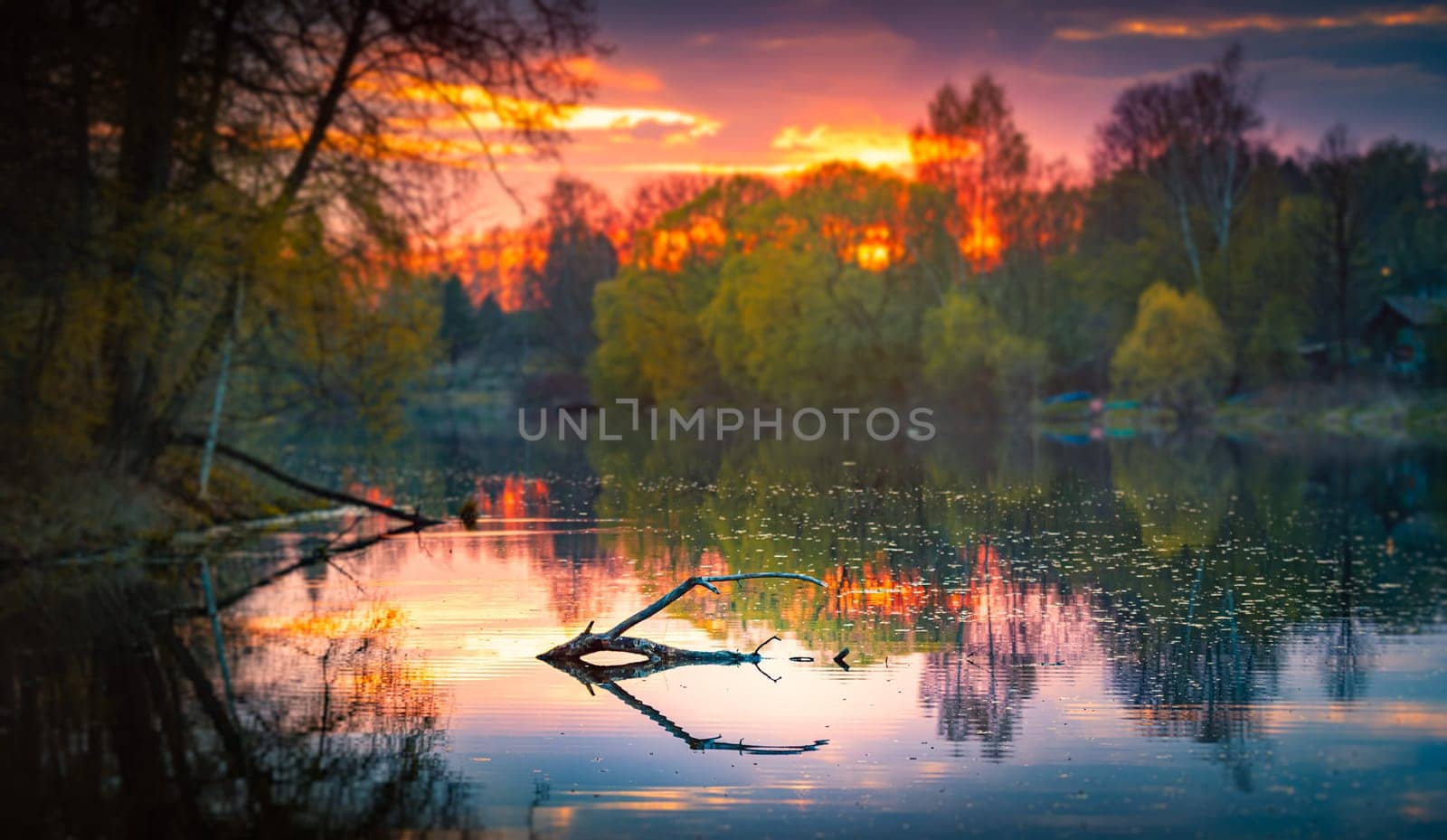 Sunset at forest river in fall. Evening sky in background