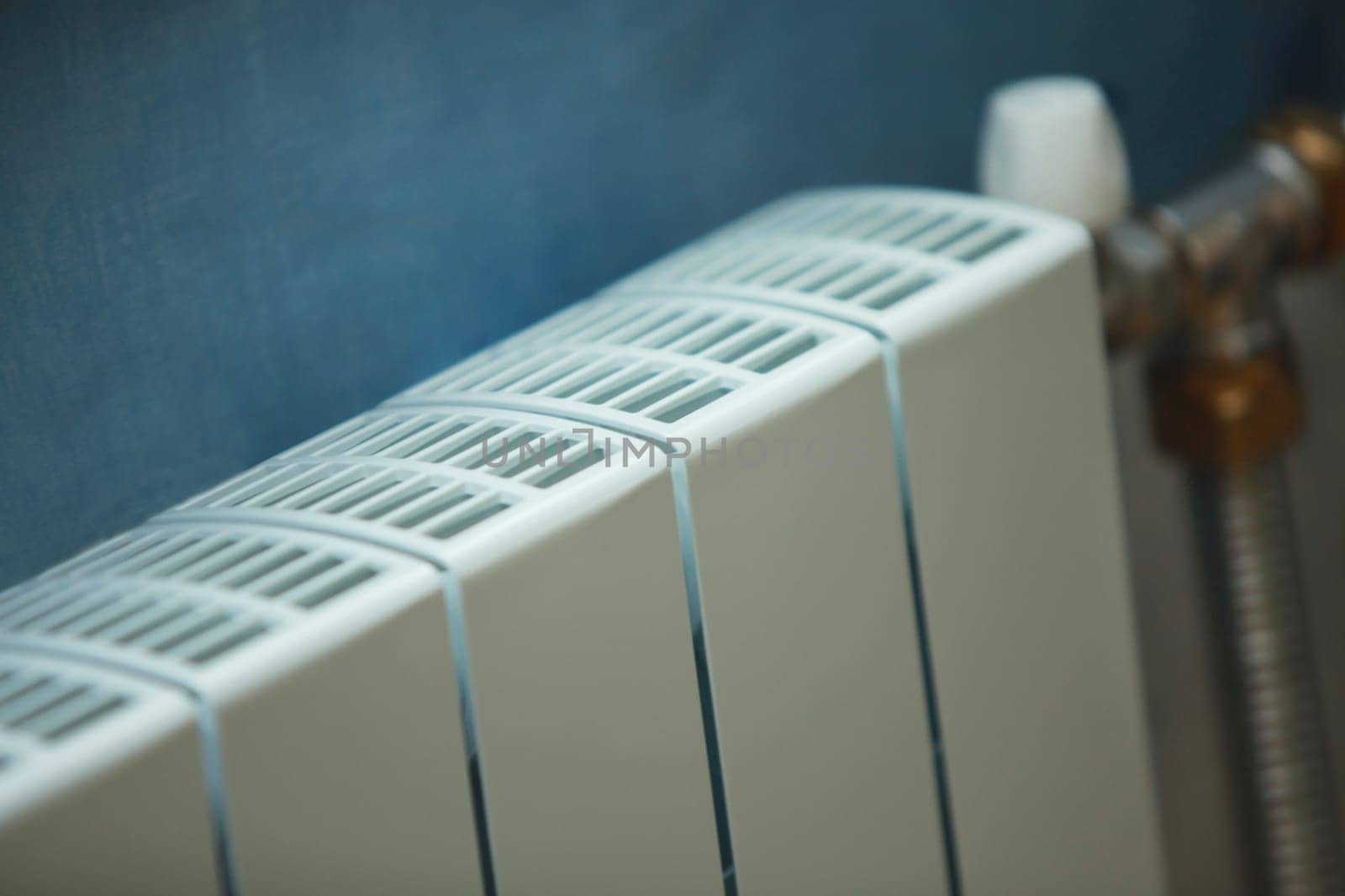 white modern radiator water heating  close-up, cold winter concept