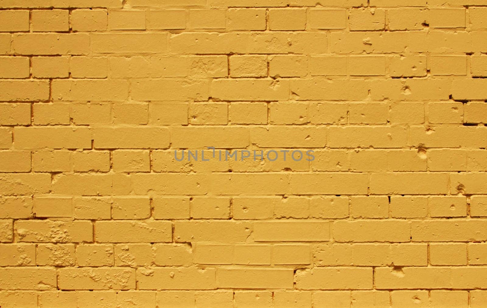 Background pattern texture made from a bright yellow brick wall