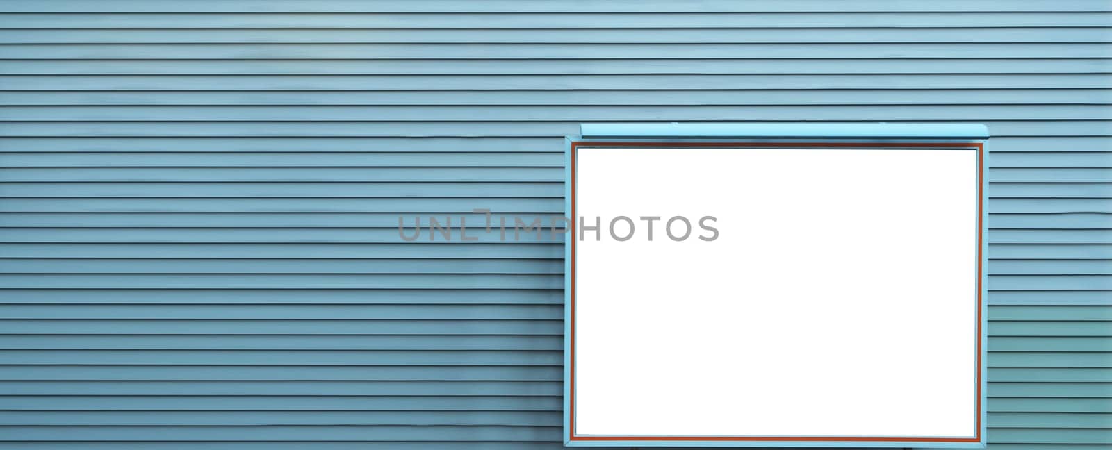 Empty indoor advertising display board on blue wall