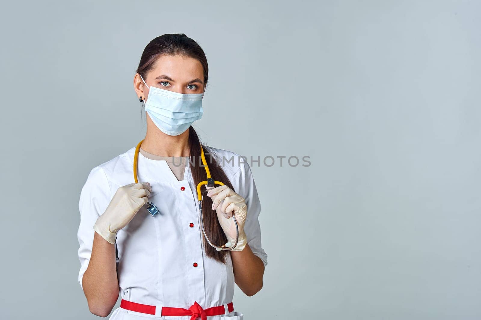 a doctor in a medical mask and a white coat with a stethoscope. High quality photo