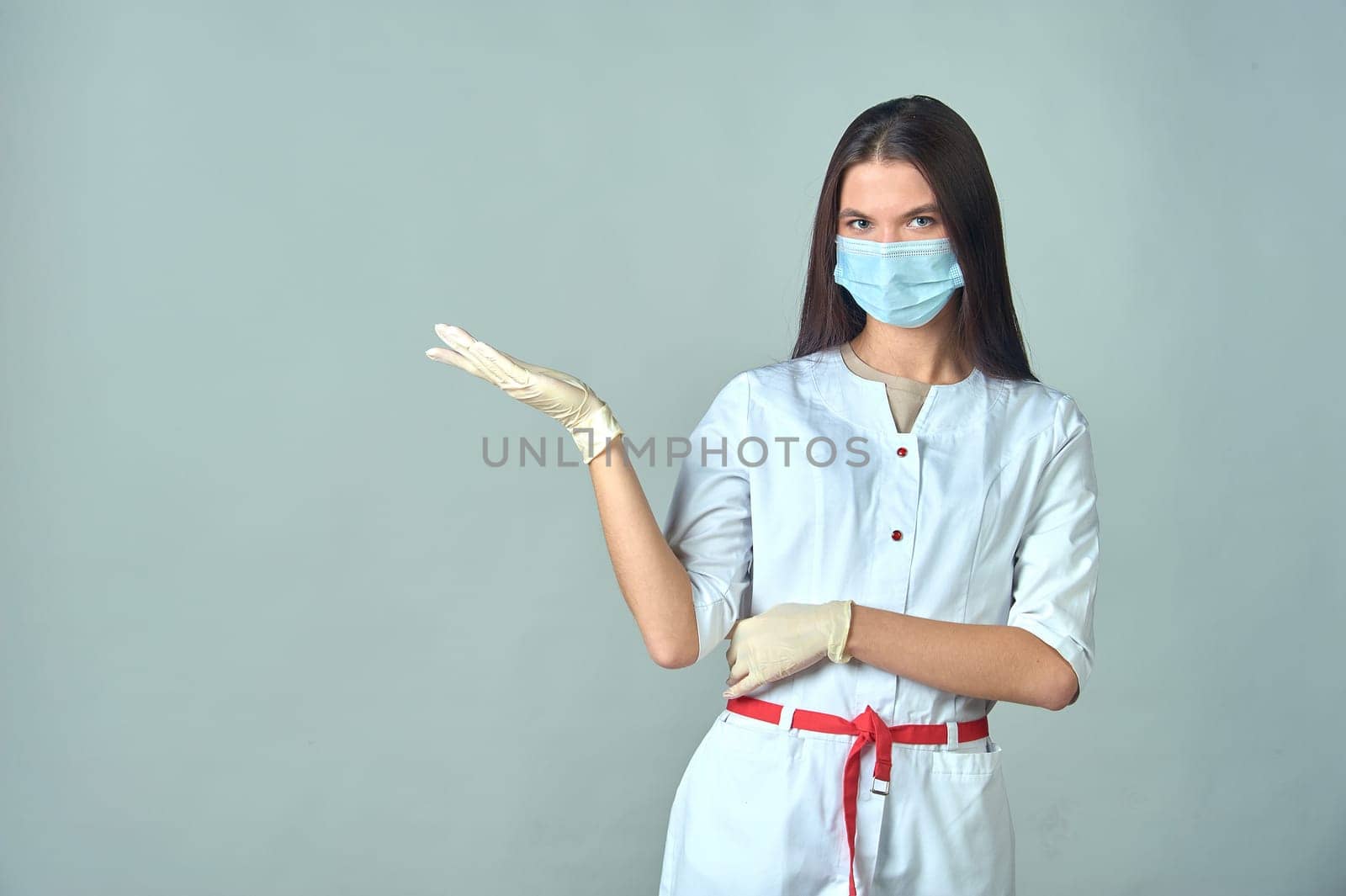 a female doctor in a medical gown warns about something important. High quality photo
