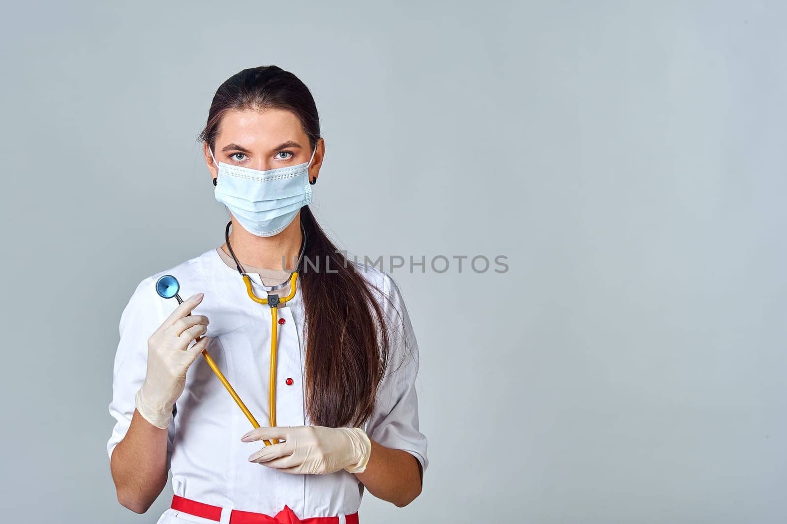 a doctor in a medical mask and a white coat with a stethoscope. High quality photo