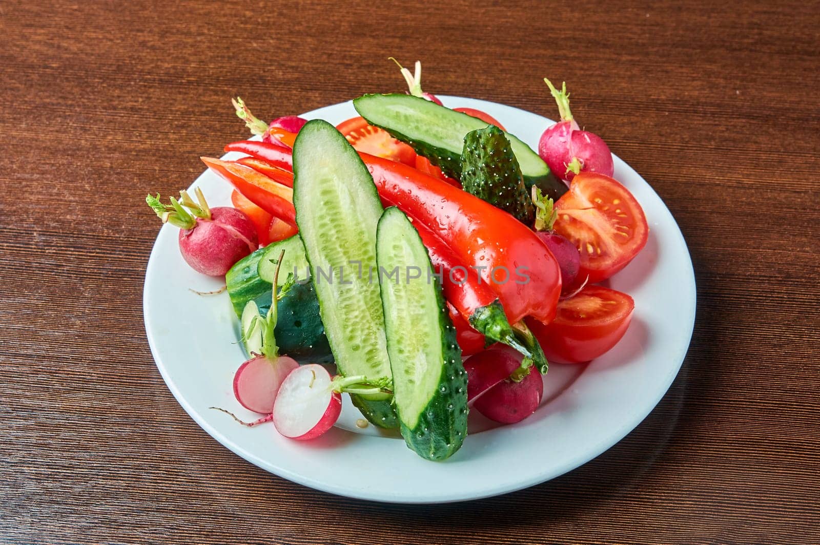 slicing fresh vegetables on a plate. High quality photo