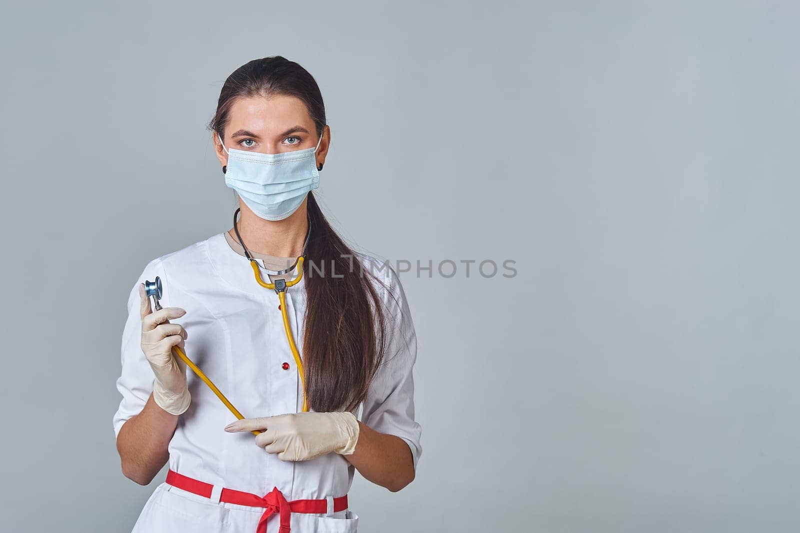 a doctor in a medical mask and a white coat with a stethoscope. High quality photo