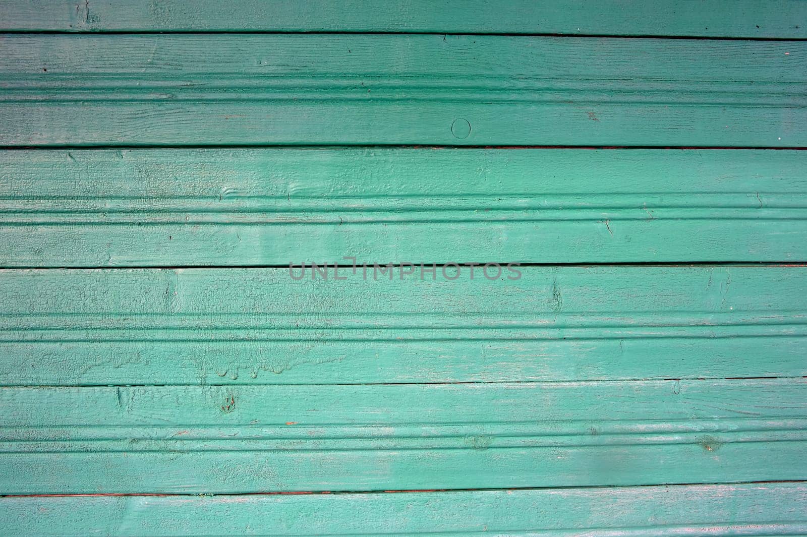 part of the wall is made of boards clapboard painted in green. High quality photo