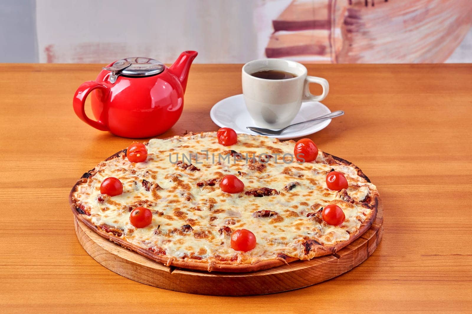pizza Lombardy lies on a stand with tea and a kettle. High quality photo