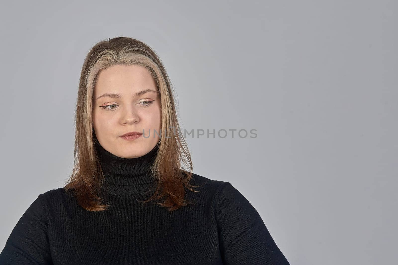 Pensive woman in the background, space for text. Thinks about the answer to the question. High quality photo