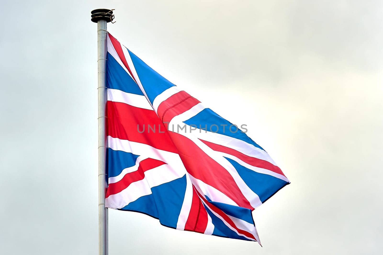 the flag of Great Britain is flying on the flagpole. High quality photo