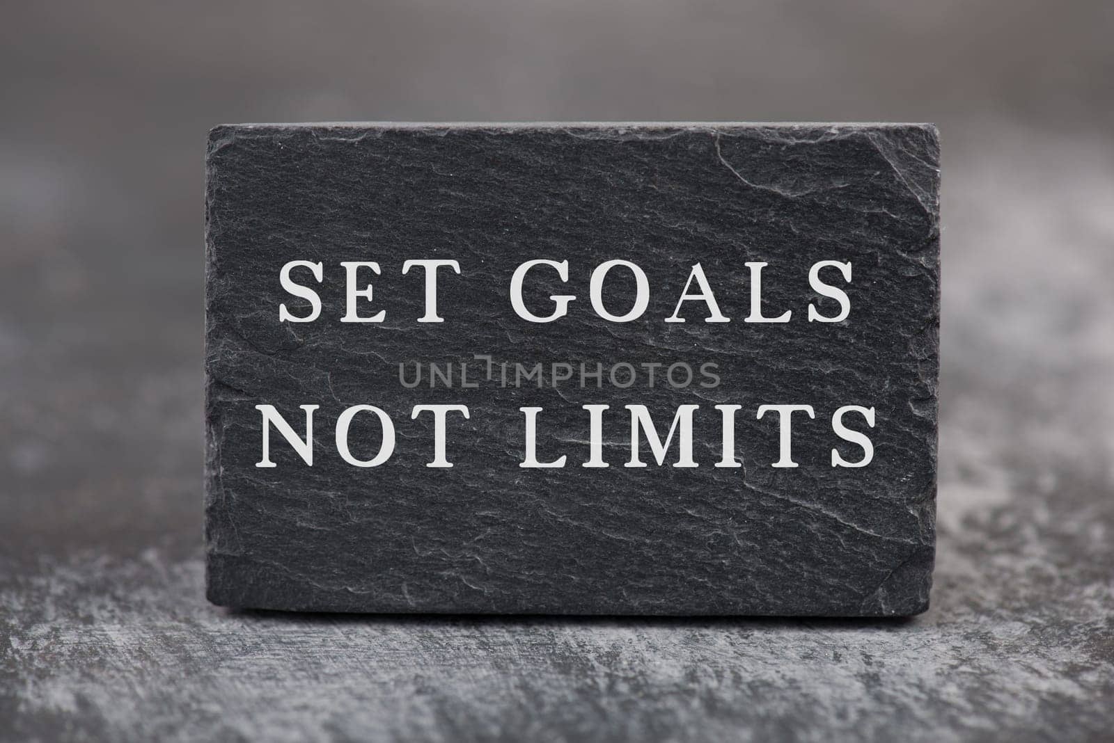 The phrase set goal not limits is standing on a textured background, business strategy, positive lifestyle