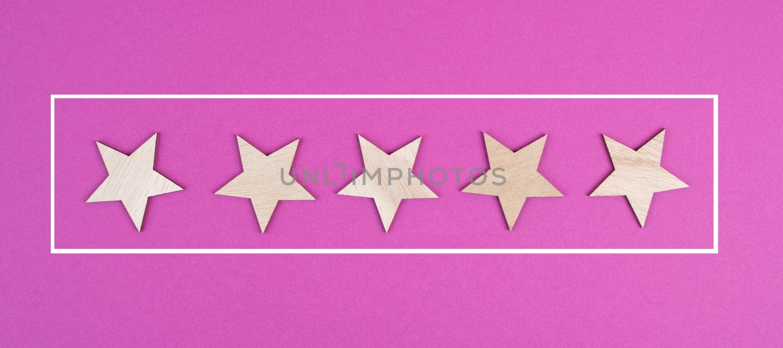 Five stars on a colored background, hand put the last star in the row, rating, giving feedback