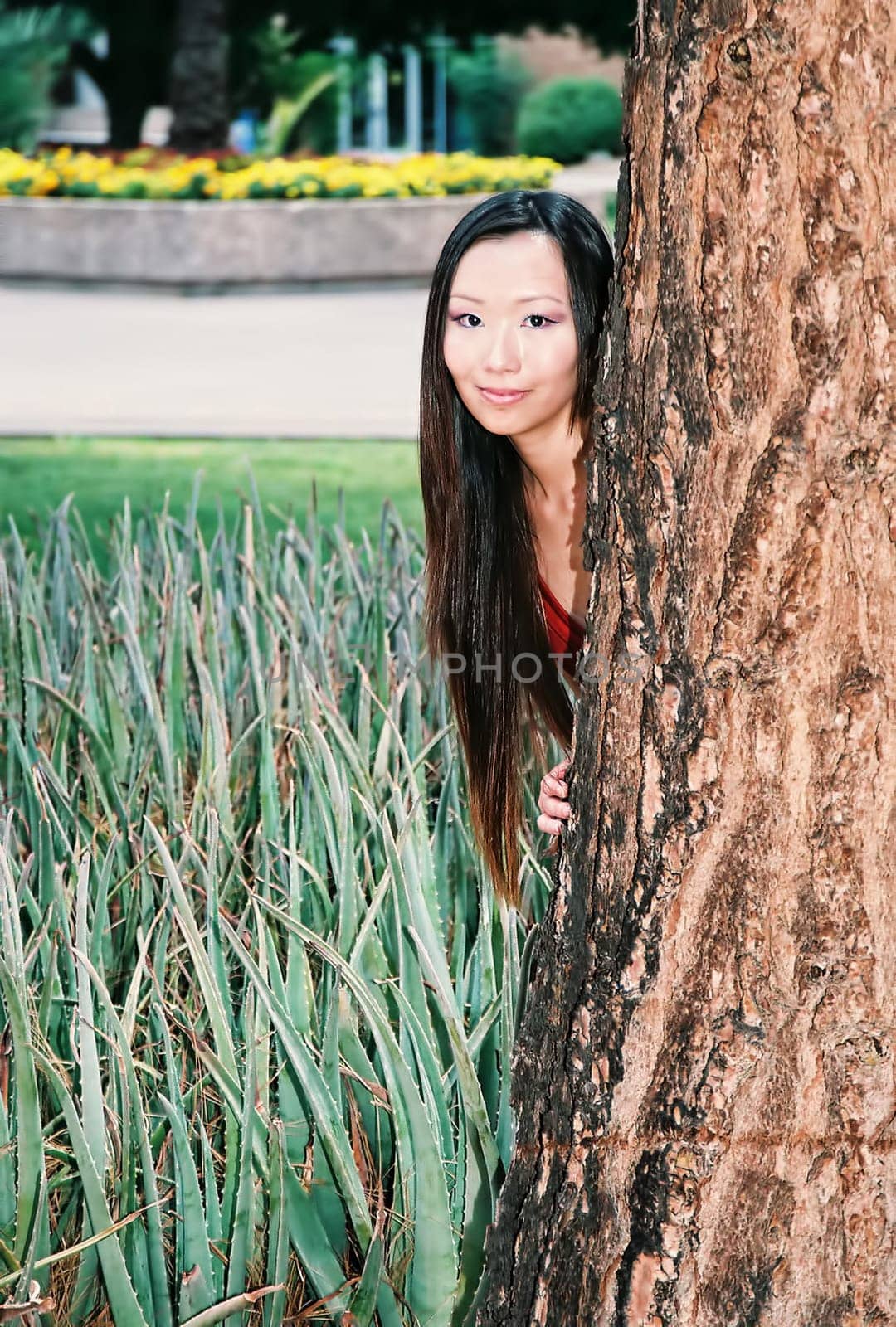 A lovely Asian female model posing outdoors