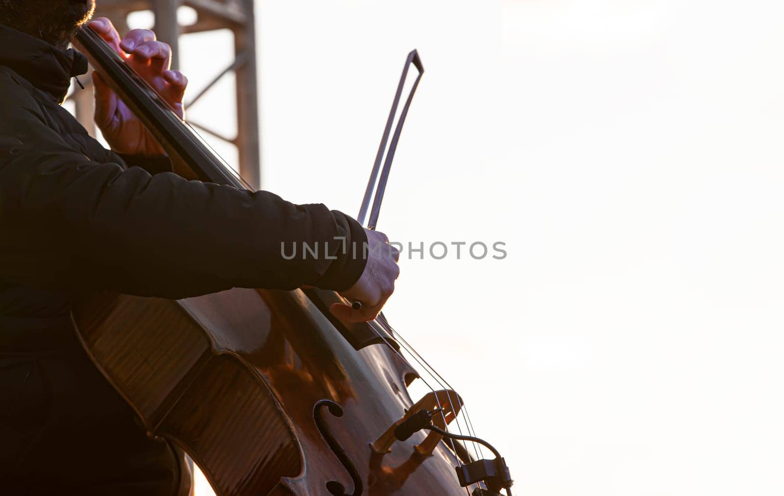 The street musician cello plays music outdoors