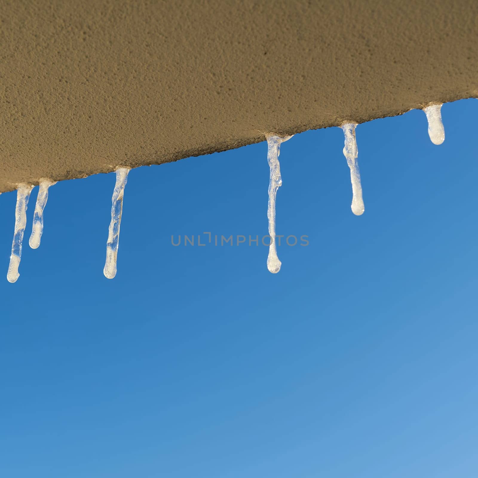 Icicles when looking out of the window of a house in winter