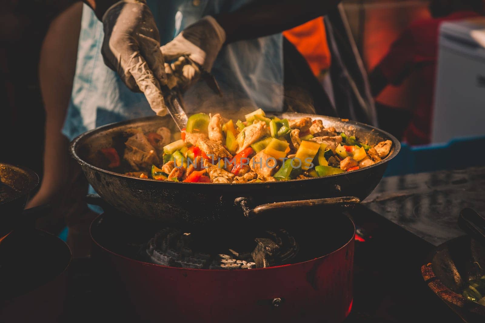 Cheff cooking fusion international cusine on street stall on international street food festival of Odprta kuhna, Open kitchen event, in Ljubljana, Slovenia.