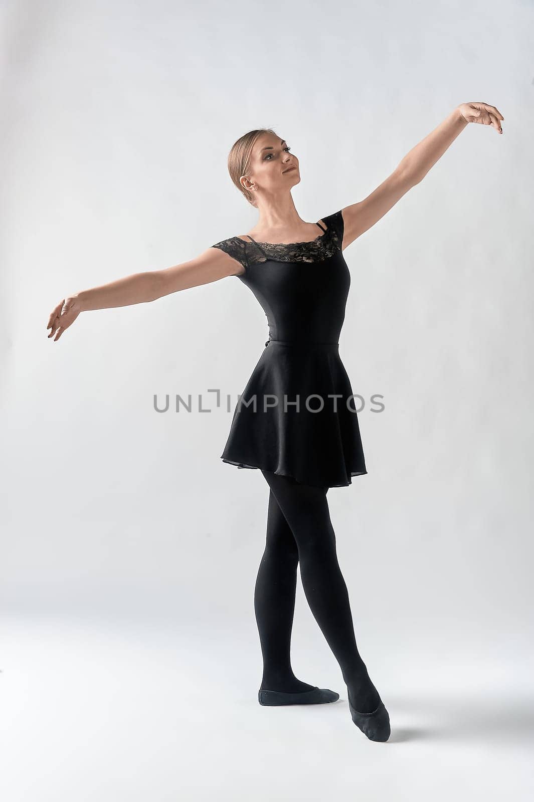 a dancer, on a white background. A dancing woman. The ballerina stands at full height. High quality photo