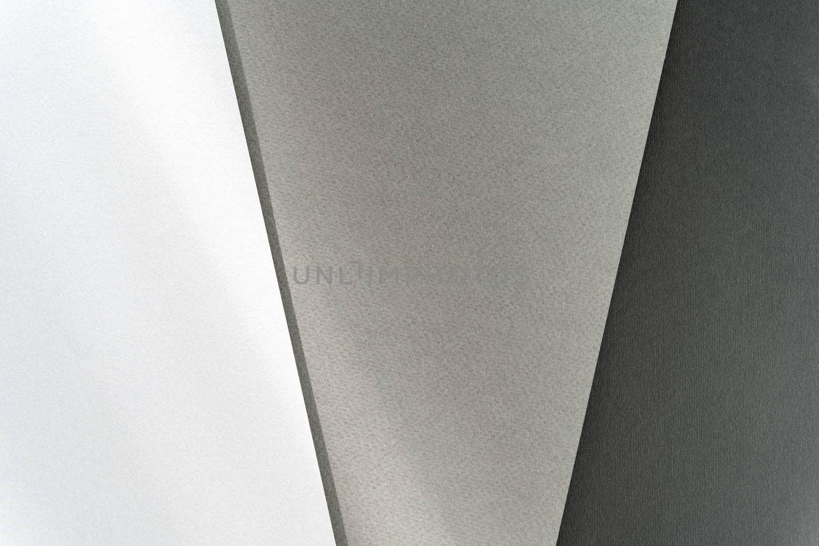 Abstract geometric backgrounds in white, gray, and black.