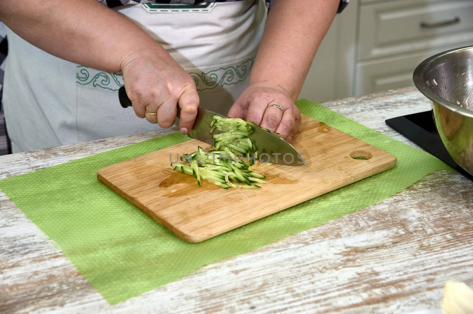 slicing cucumber for salad, on a cutting Board. High quality photo