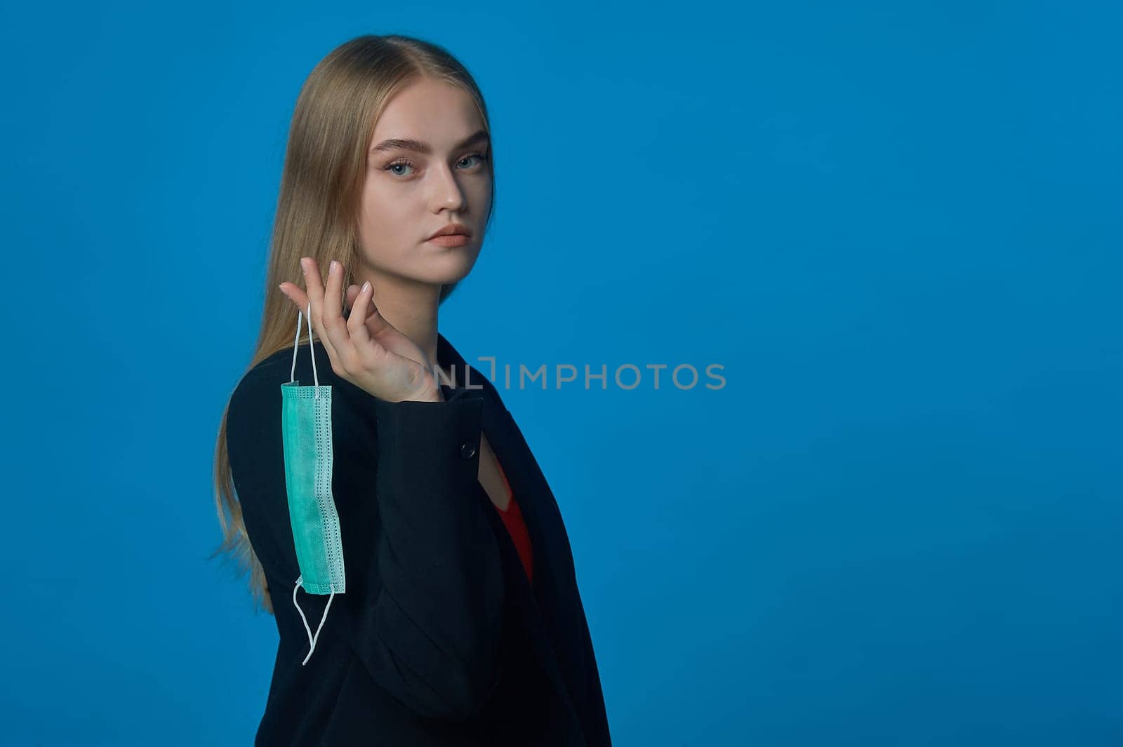 Girl with a medical mask on her finger. High quality photo