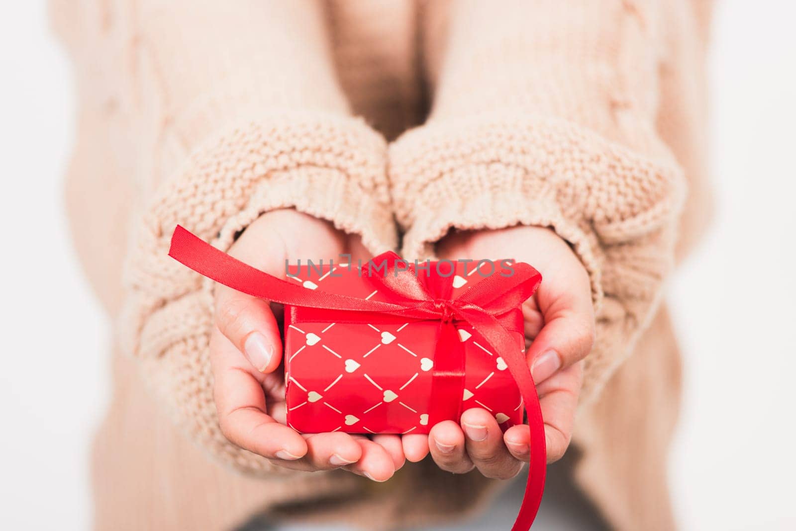 Valentine Day. Woman beauty hands holding small gift package box present wrapped paper with ribbon, Christmas, New year, Birthday holiday background concept