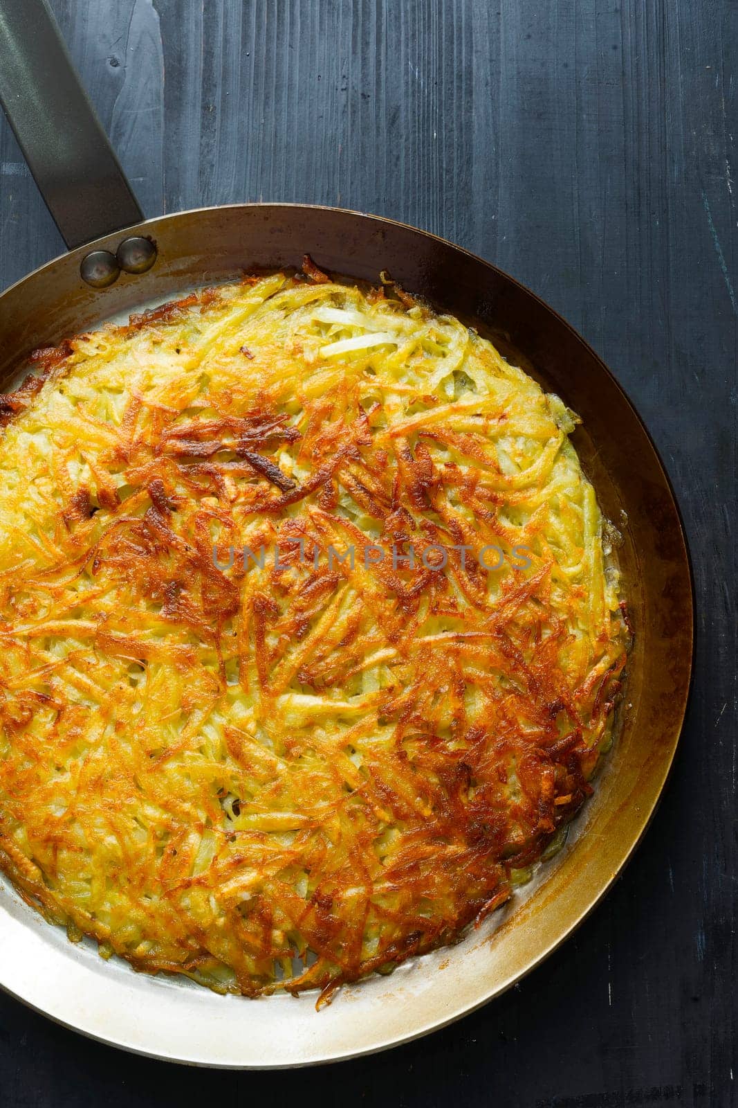 close up of a pan of golden swiss rosti fried potato pancake