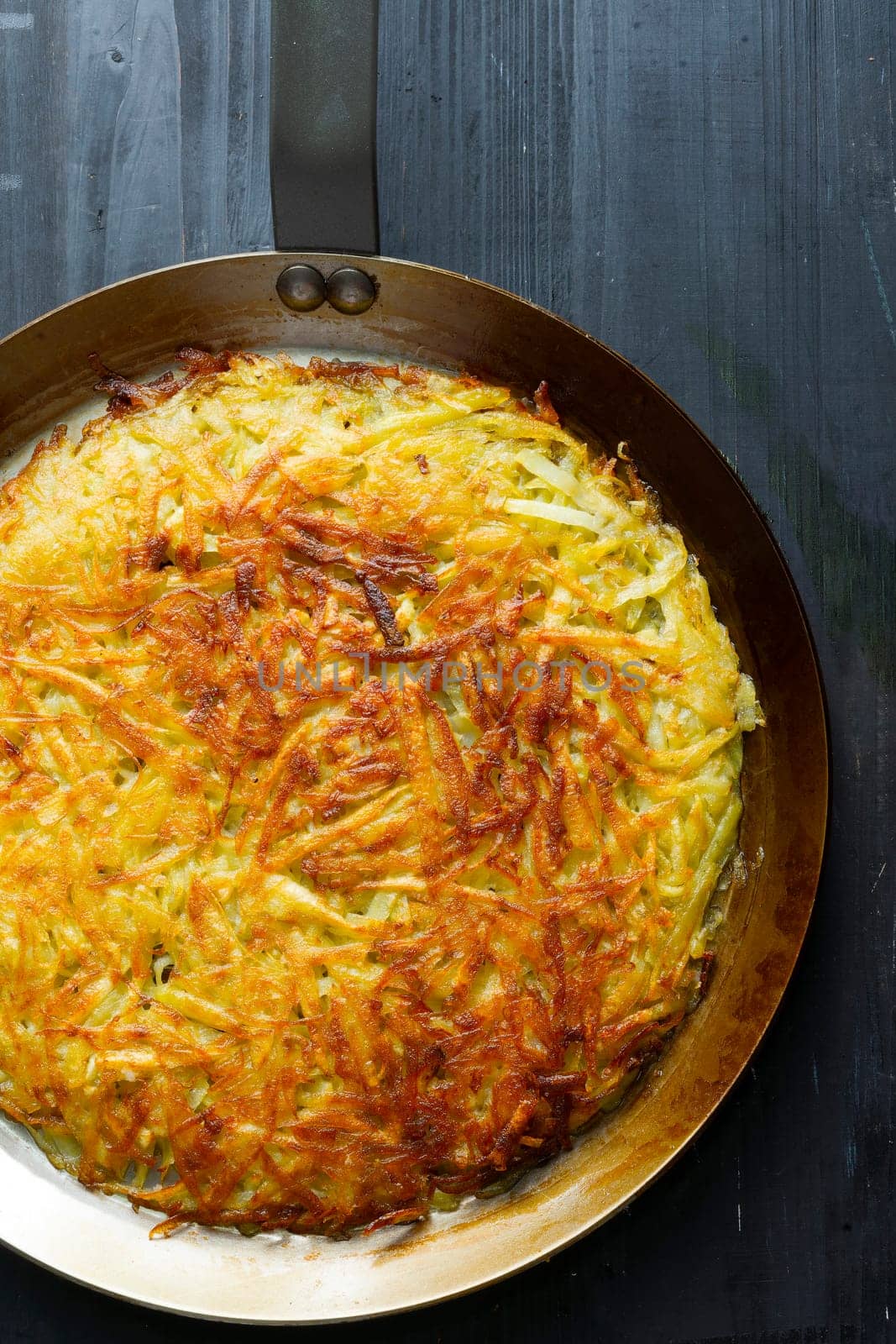 close up of a pan of golden swiss rosti fried potato pancake