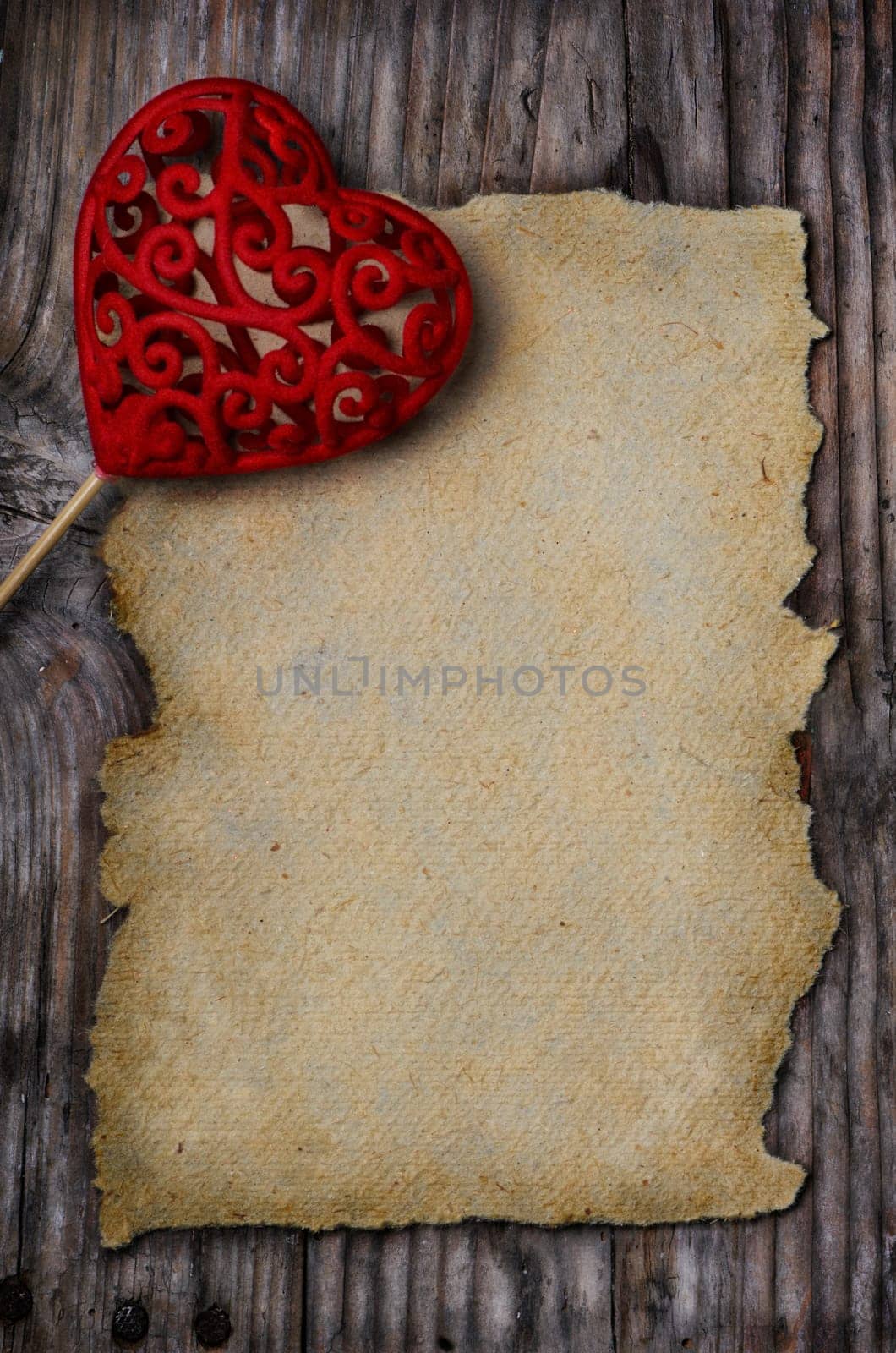 Valentine heart and old empty page on wooden background