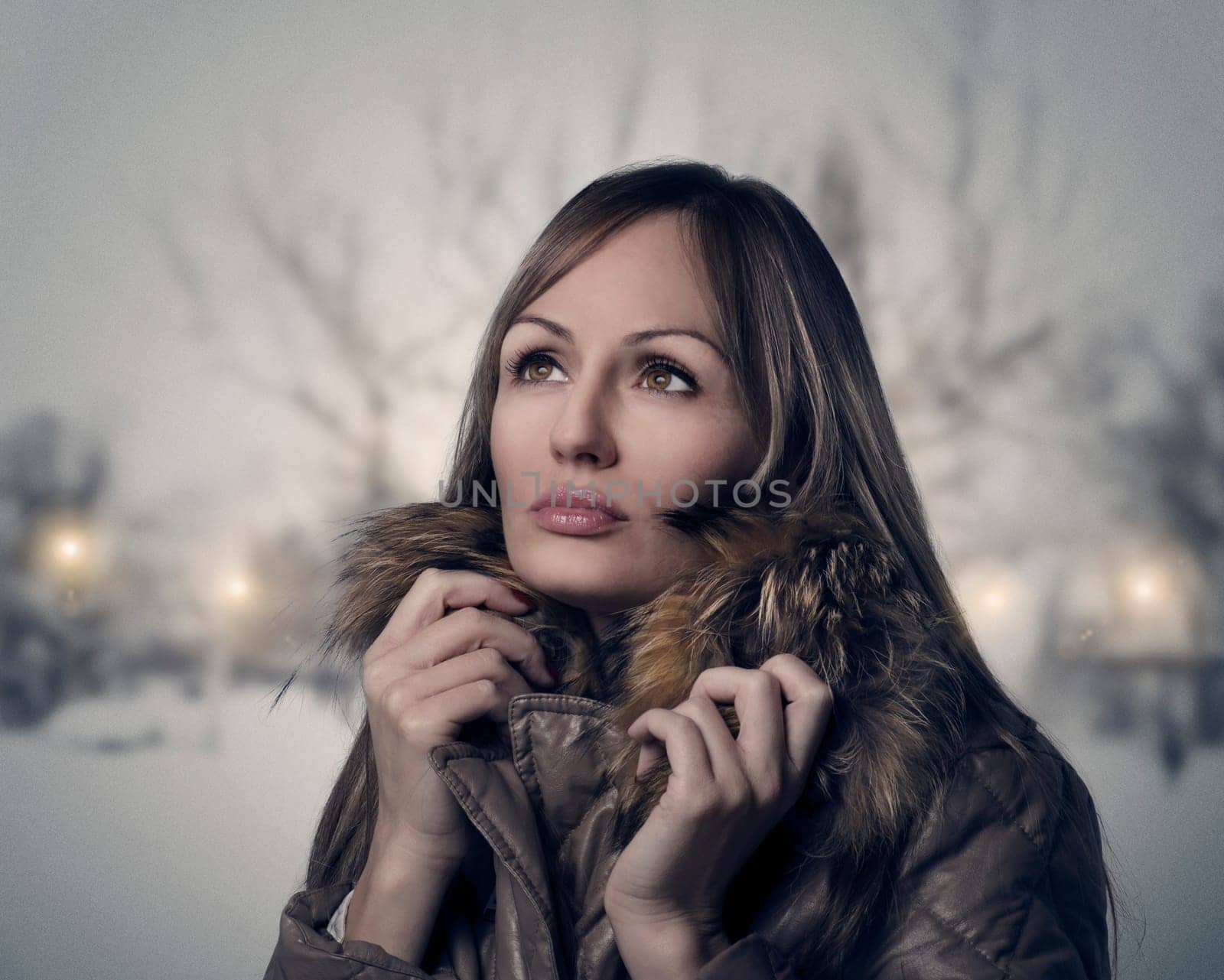 Woman walking in the park on a snowy evening