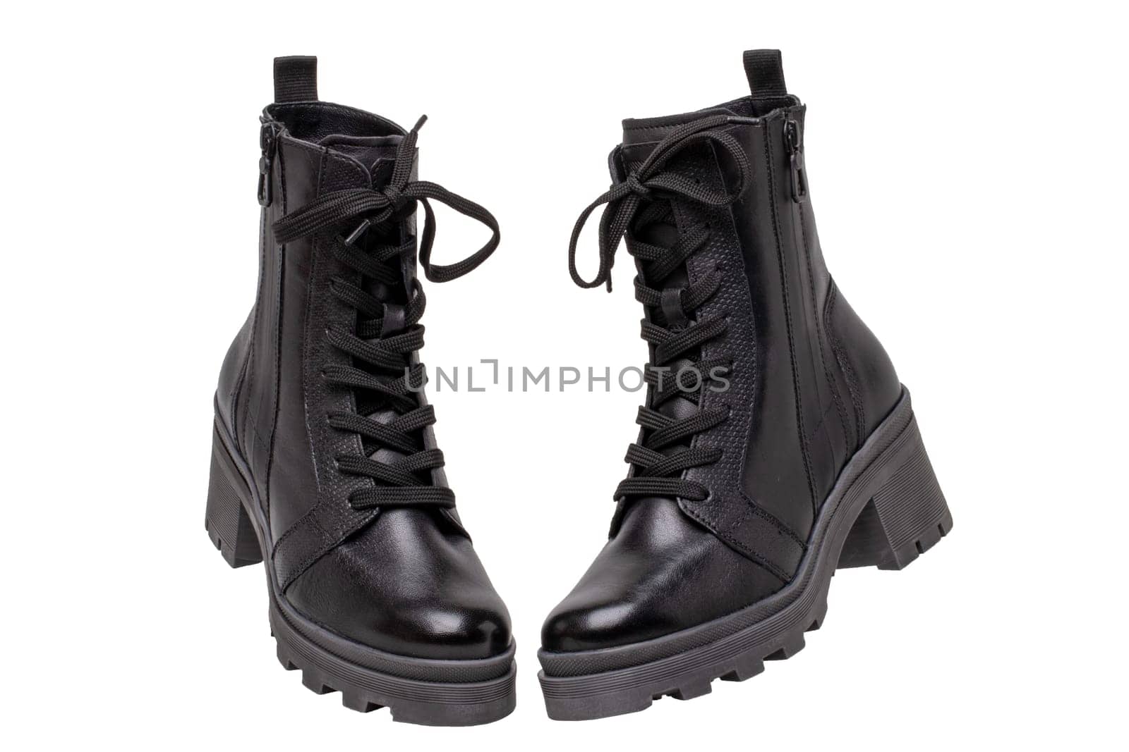 Womens boots and shoes. Closeup of female elegant black leather winter boots. Latest trends of winter shoe fashion for girls isolated on white background. Macro.