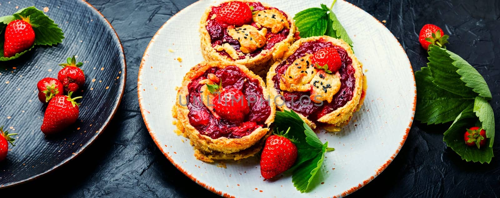 Delicious tartlets with berry jam.Cake with strawberries.Long banner