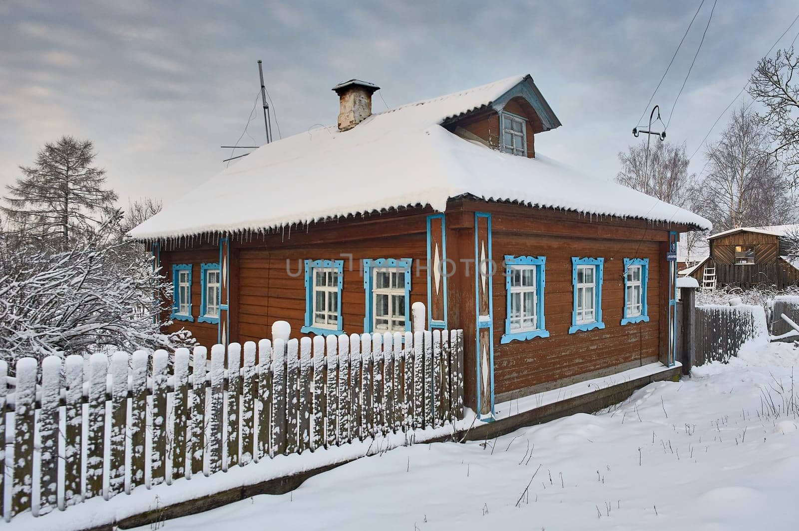 Village hut in winter at sunset in the countryside. High quality photo