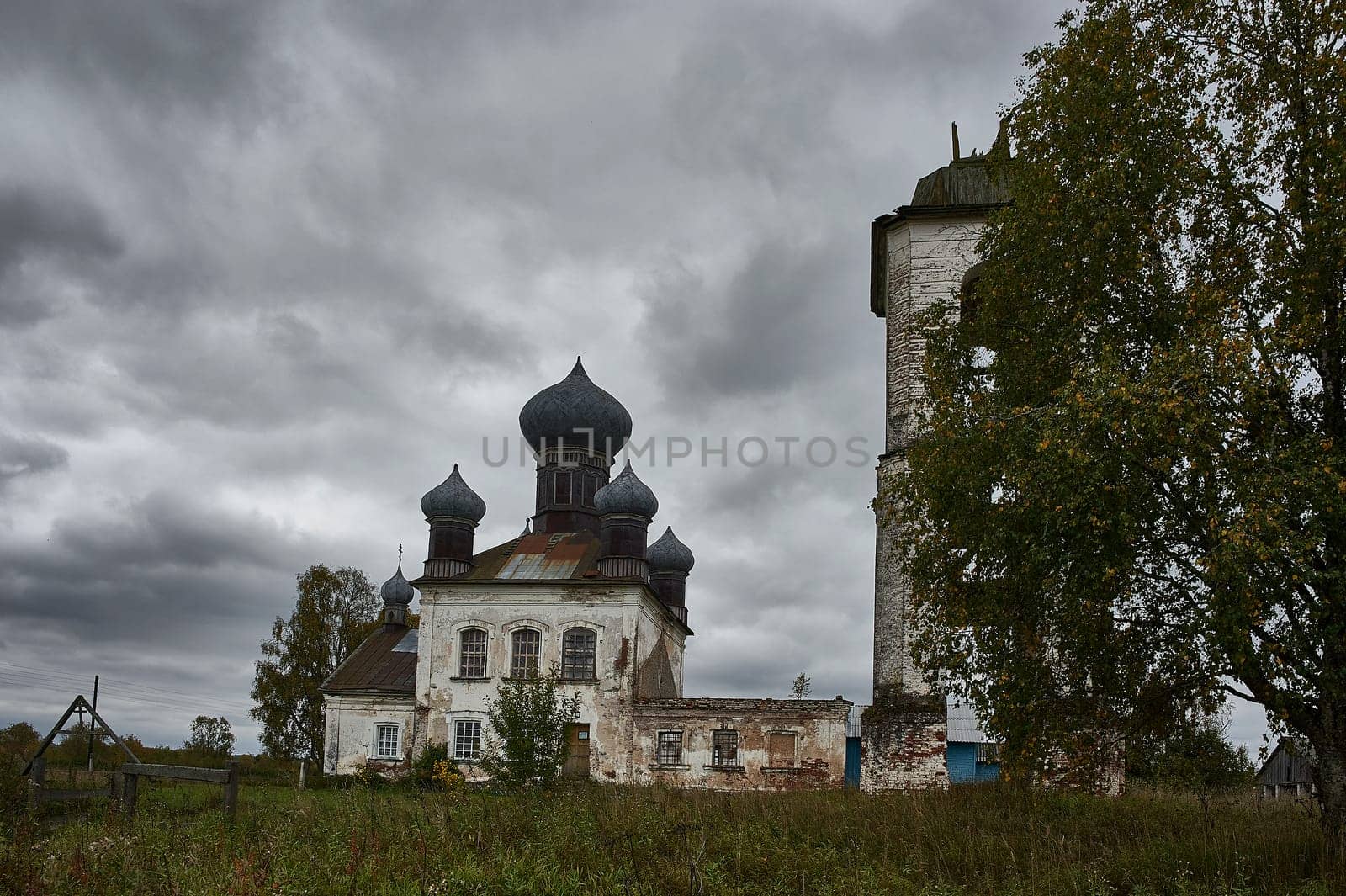 An ancient ruined Church with a bell tower in a field. High quality photo