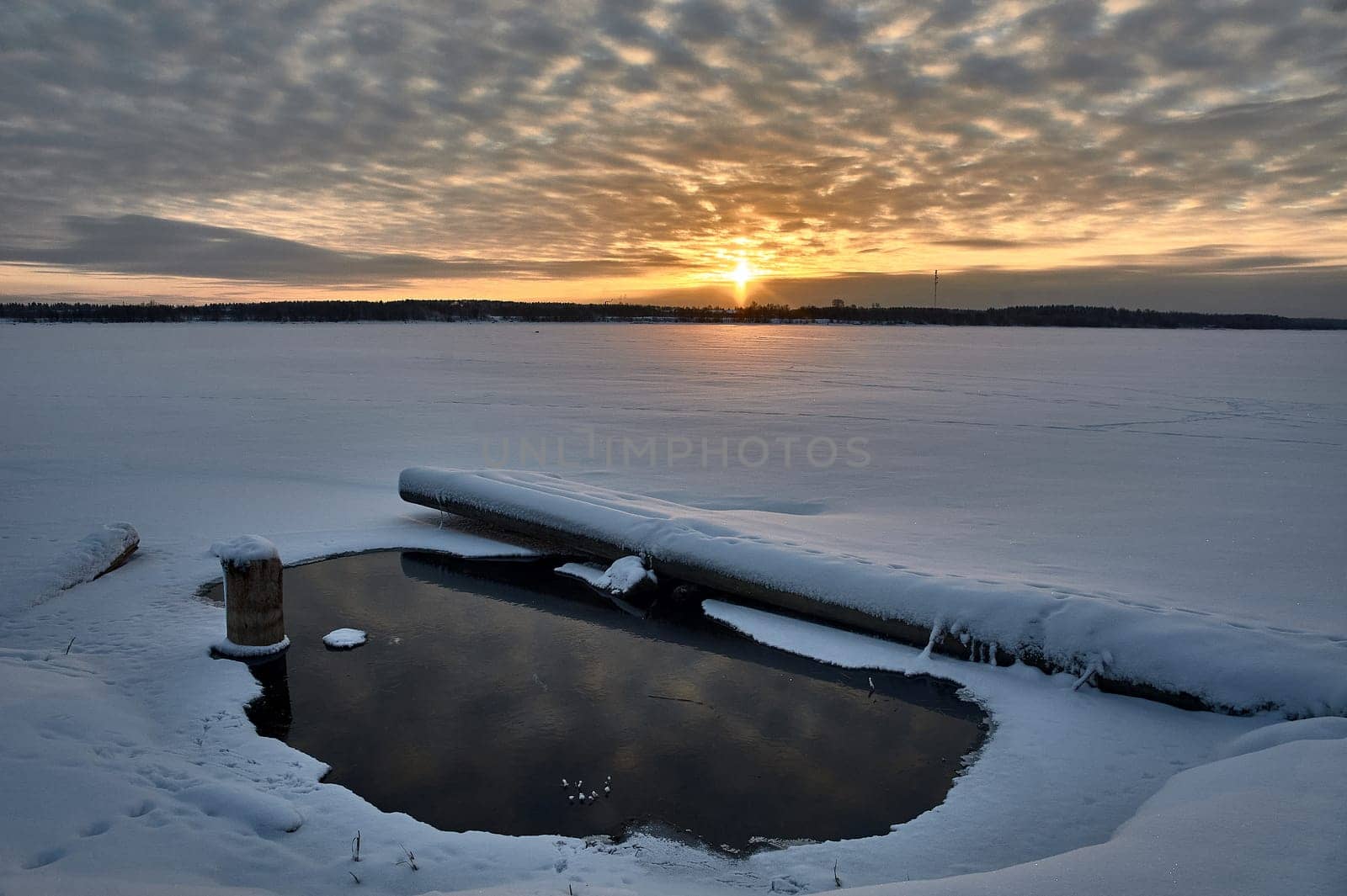 Winter sunset on the river in the month of January. High quality photo