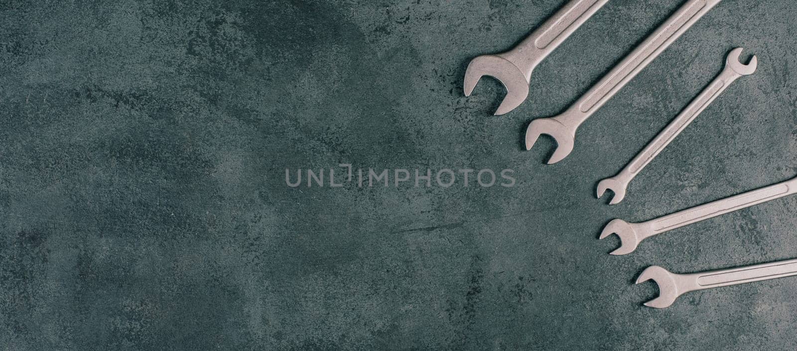 Wrenches tools on a dark textured background, copy space for text, repair and construction works, Labor Day