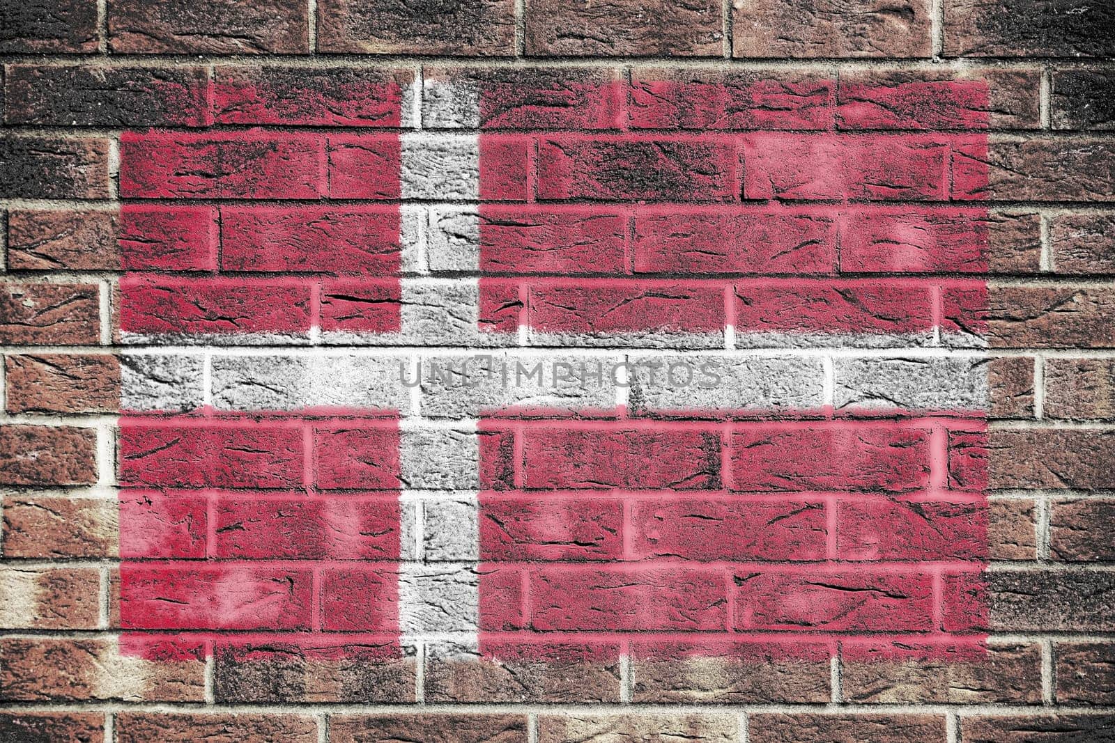 A Denmark flag painted on brick wall background