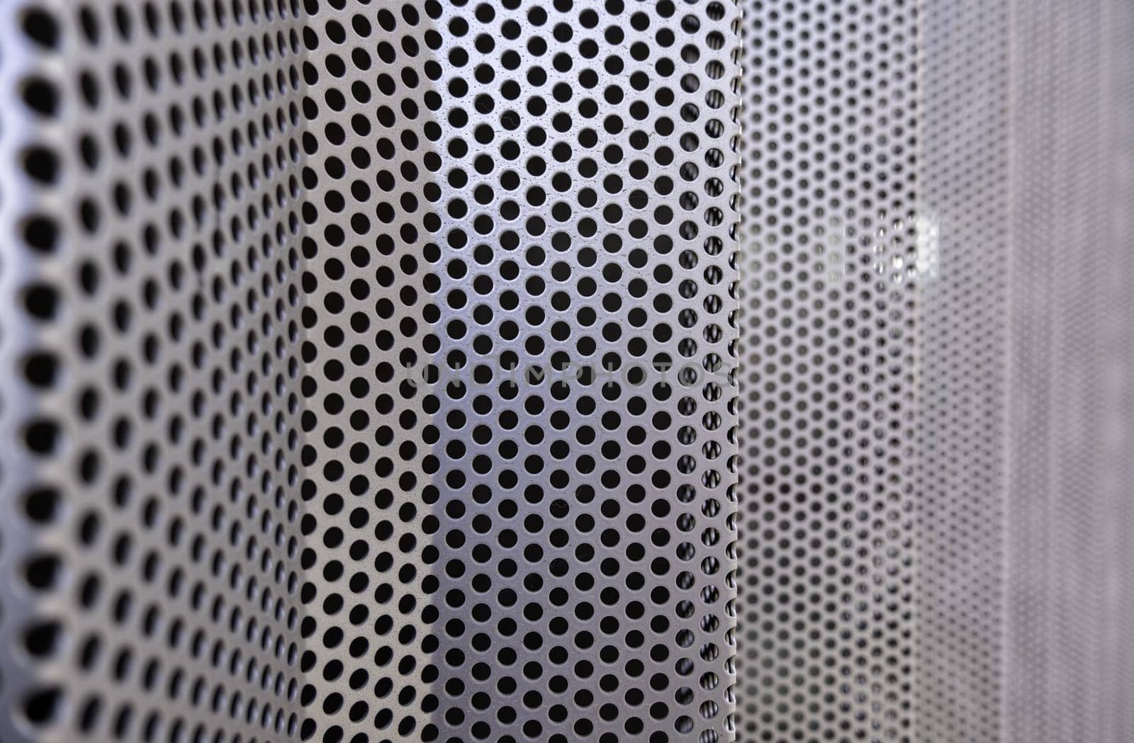 Detail of metal wall decorated with holes