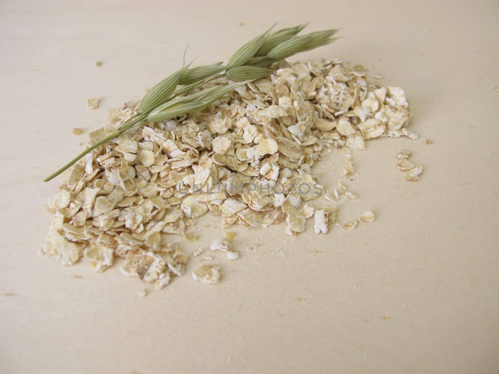 Fine rolled oats flakes on a wooden board