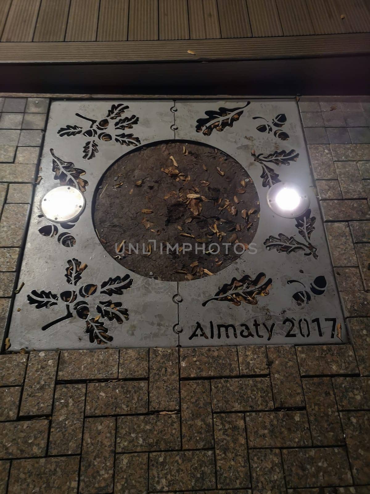ALMATY, KAZAKHSTAN - NOVEMBER 8, 2019: Side grating, perforated with images of oak leaves and acorns with the inscription Almaty 2017.
